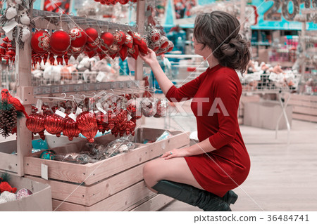 customer girl choosing decoration balls for customer girl choosing decoration balls for 36484741