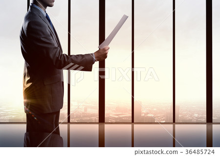 Businessman reading documents Businessman reading documents 36485724