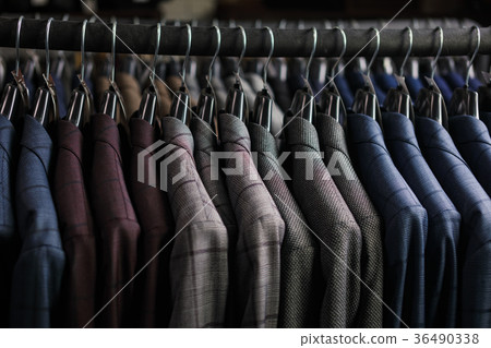 Row of men suit jackets on hangers Row of men suit jackets on hangers 36490338