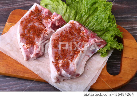 Raw pork steak with spices Leaves lettuc 36494264