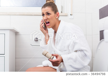 Woman on toilet complaining via phone about lack Woman on toilet complaining via phone about lack 36494798