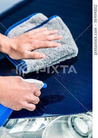 Hands cleaning car with spray cleaner and Hands cleaning car with spray cleaner and 36494802