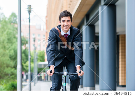 Active young man smiling while riding utility Active young man smiling while riding utility 36494815