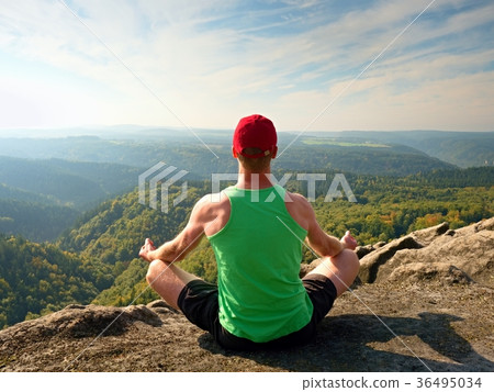 Slim body hiker in singlet and black shorts sit 36495034