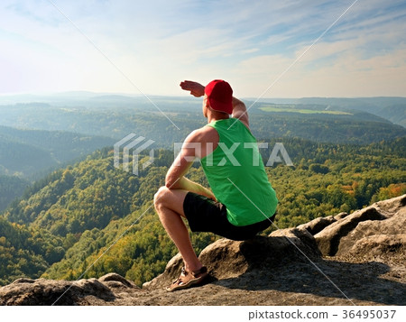 Slim body hiker sit on rock, enjoy natural scenery 36495037