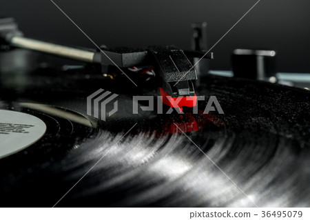 Old record player stylus on a rotating disc Old record player stylus on a rotating disc 36495079