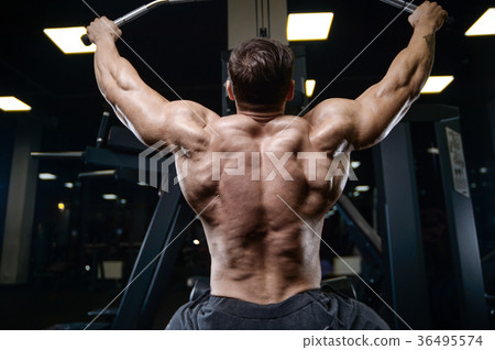 Brutal strong bodybuilder athletic men pumping up muscles with d Brutal strong bodybuilder athletic men pumping up muscles with d 36495574