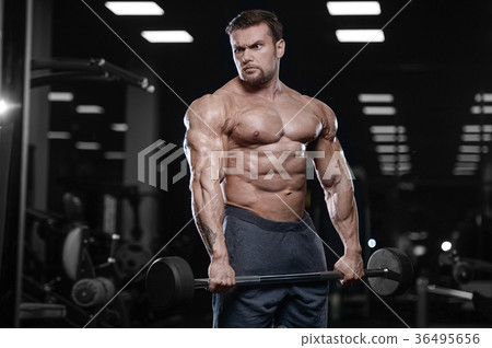Brutal strong bodybuilder athletic men pumping up muscles with d 36495656