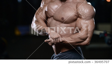 Brutal strong bodybuilder athletic men pumping up muscles with d Brutal strong bodybuilder athletic men pumping up muscles with d 36495707