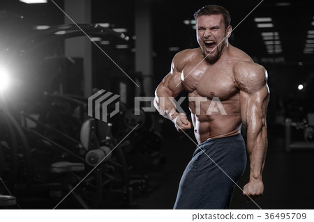 Brutal strong bodybuilder athletic men pumping up muscles with d Brutal strong bodybuilder athletic men pumping up muscles with d 36495709