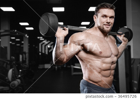 Brutal strong bodybuilder athletic men pumping up muscles with d 36495726