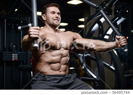 Brutal strong bodybuilder athletic men pumping up muscles with d 36495744