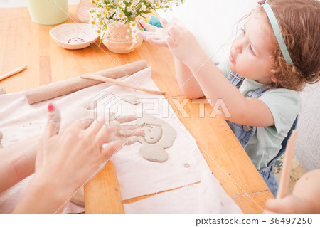 Happy children are engaged with modeling clay Happy children are engaged with modeling clay 36497250