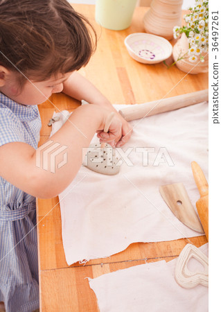 Happy children are engaged with modeling clay Happy children are engaged with modeling clay 36497261