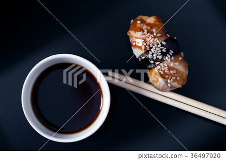 Eel sashimi, soy sauce and chopsticks, top view Eel sashimi, soy sauce and chopsticks, top view 36497920
