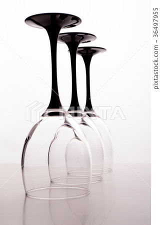 Closeup of three transparent crystal wine glasses 36497955