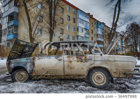 burnt out car near an apartment building burnt out car near an apartment building 36497998