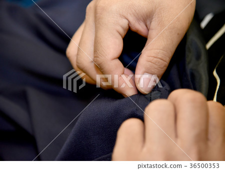 hands of Tailor man working in his cloth fabric hands of Tailor man working in his cloth fabric 36500353