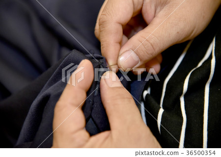 hands of Tailor man working in his cloth fabric hands of Tailor man working in his cloth fabric 36500354