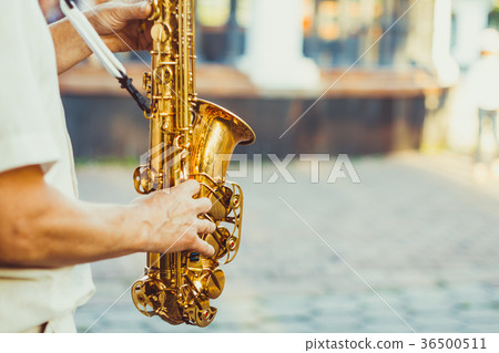 saxophonist plays on the street 36500511