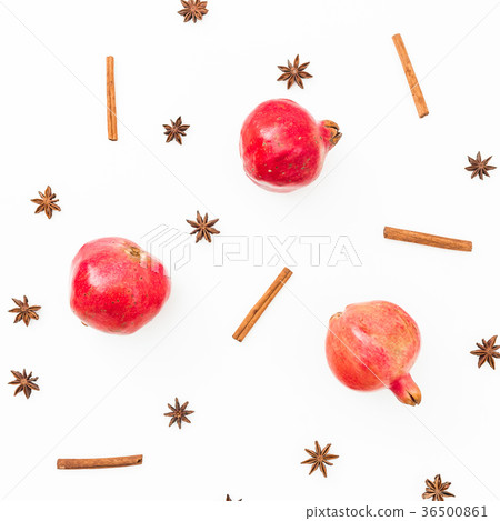 Red garnet fruit, cinnamon and anise on white back Red garnet fruit, cinnamon and anise on white back 36500861
