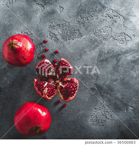 Red garnet fruit on dark background. Flat lay, top Red garnet fruit on dark background. Flat lay, top 36500863