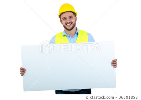 Happy male engineer holding an advertisement blank 36501858