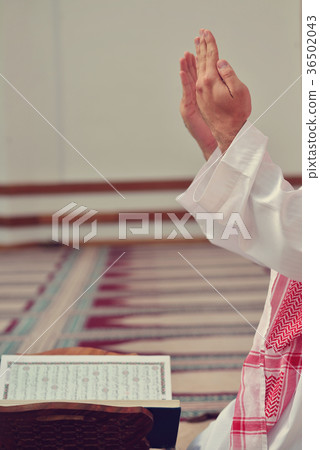 Hand of muslim people praying with mosque interior 36502043