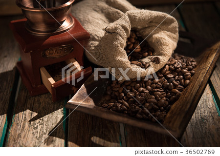 Coffee mill on dark rustic background. Wood table Coffee mill on dark rustic background. Wood table 36502769