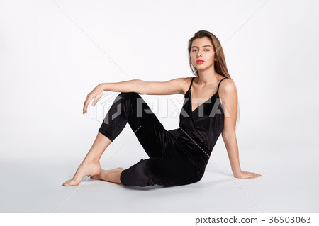 Attractive happy girl is possing and smilling in flower red dress and black hat on white Attractive happy girl is possing and smilling in flower red dress and black hat on white 36503063