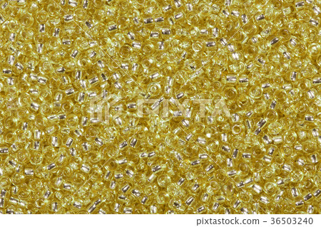 Background of golden yellow glass beads. 36503240