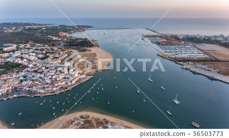 Aerial. Ferragudo at sunset shooting from the sky Aerial. Ferragudo at sunset shooting from the sky 36503773