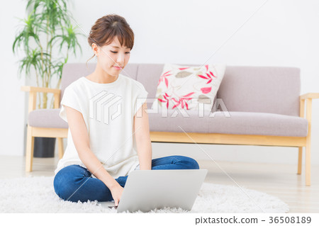 Woman looking at laptop computer in room 36508189