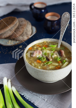 Bowl of pea soup with bread and milk 36511654
