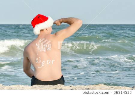 Man in Santa hat looks into the distance 36514533