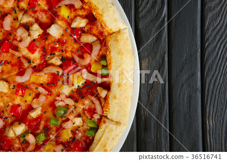 Top view of pizza with shrimps and chicken fillet Top view of pizza with shrimps and chicken fillet 36516741
