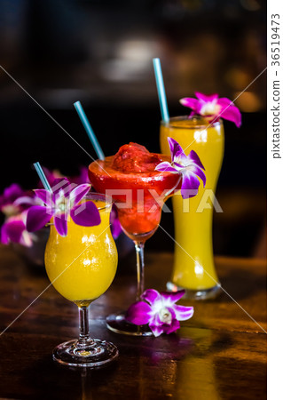 Still life with 3 cocktails and orchid flowers 36519473