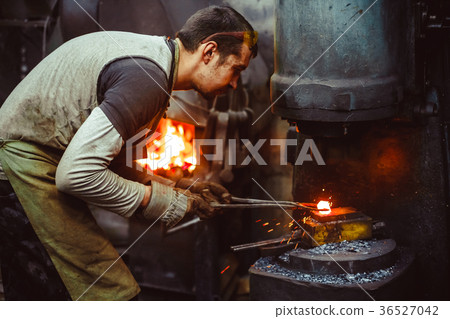 blacksmith working in the forge 36527042