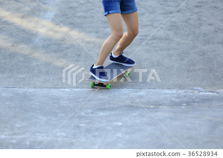 Skateboarder legs riding skateboard at skatepark Skateboarder legs riding skateboard at skatepark 36528934