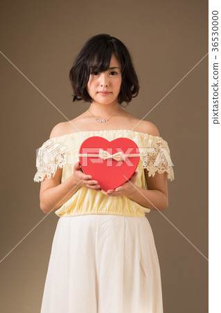 Young woman with a heart gift 36530000
