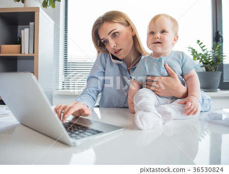 Serious businesswoman having job with kid 36530824