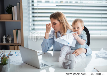 Tired woman with engaged child at job 36530836