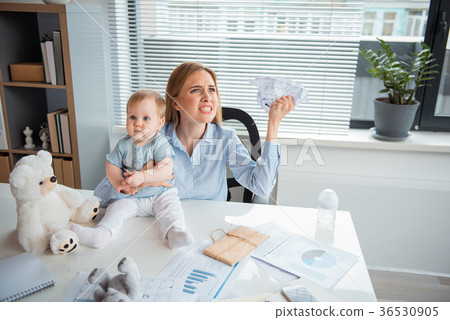 Fierce lady and happy baby in office Fierce lady and happy baby in office 36530905