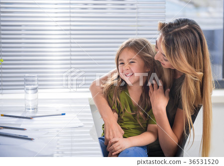 Joyful mother hugging her child with fondness 36531520