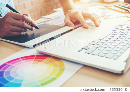 Graphic designer drawing on graphics tablet Graphic designer drawing on graphics tablet 36533048