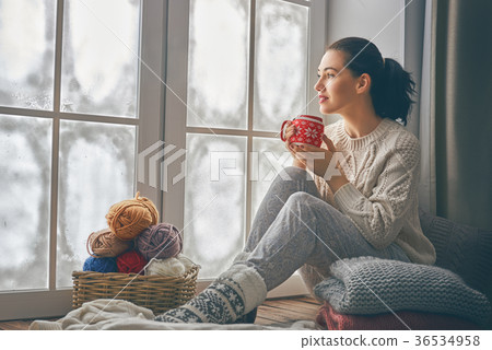 woman sitting by the window 36534958