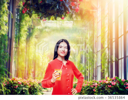 Woman drinks orange juice 36535864