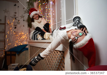 Happy mother and daughter sitting on a windowsill 36537347