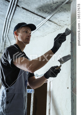 Worker gets plaster on the wall Worker gets plaster on the wall 36537678