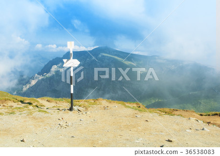 A signpost direction white sign arrow near A signpost direction white sign arrow near 36538083